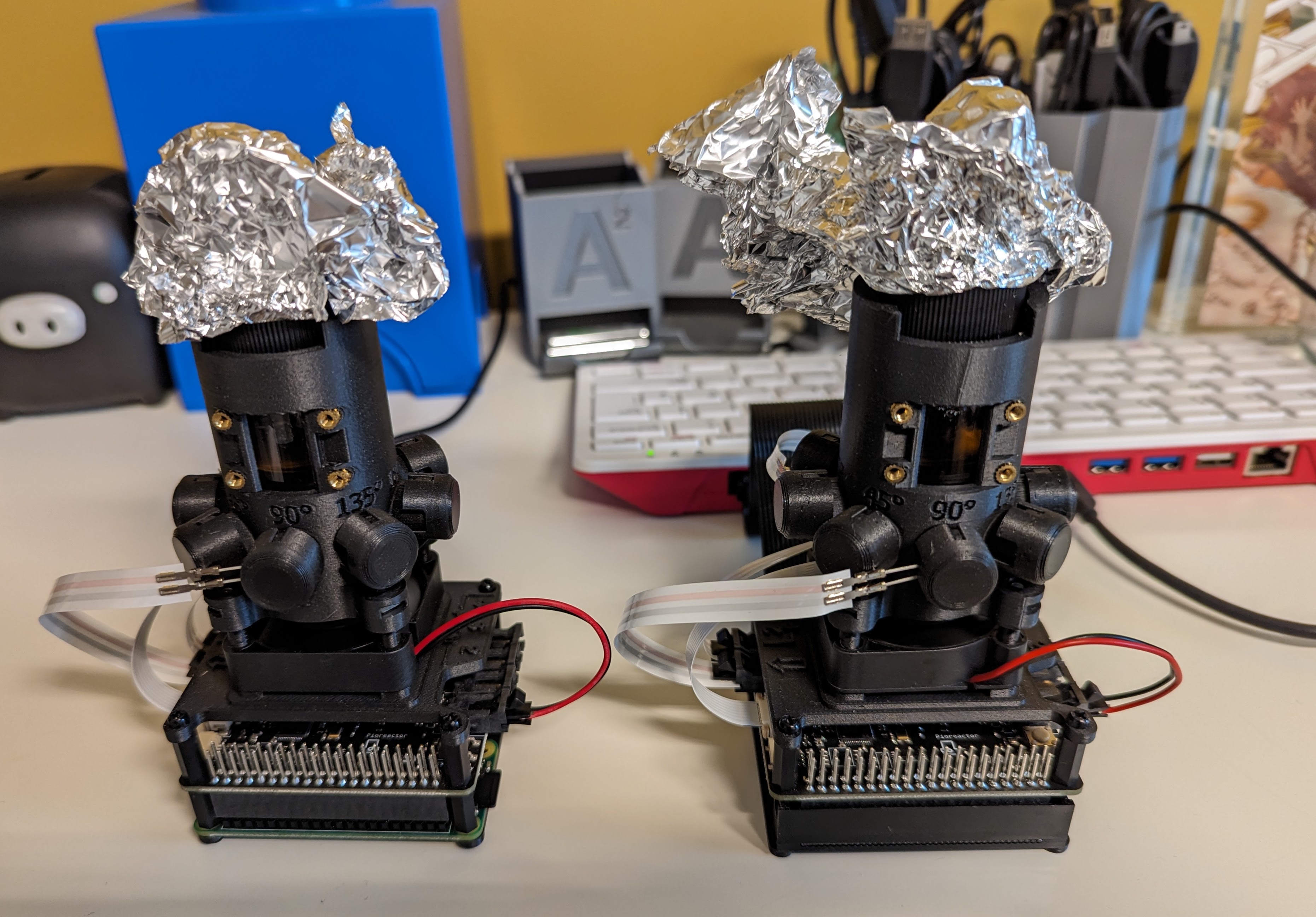 Two Pioreactors standing side by side, with the one on the right connected to a Raspberry Pi 400